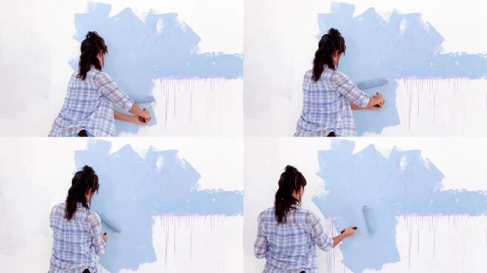 一个女人在装修刷墙特写