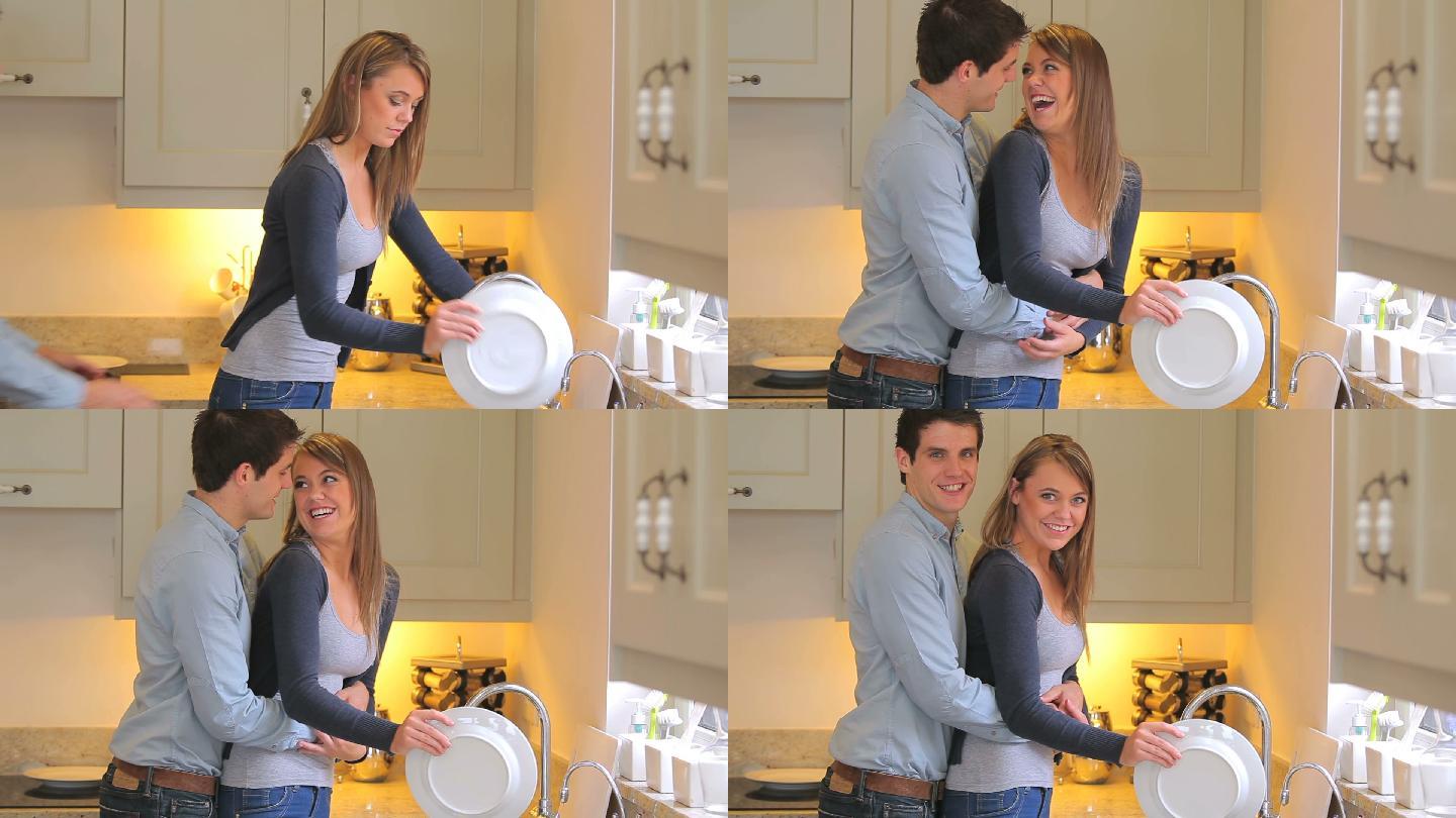 女人在厨房洗碗时，男人走到她身后拥抱亲吻