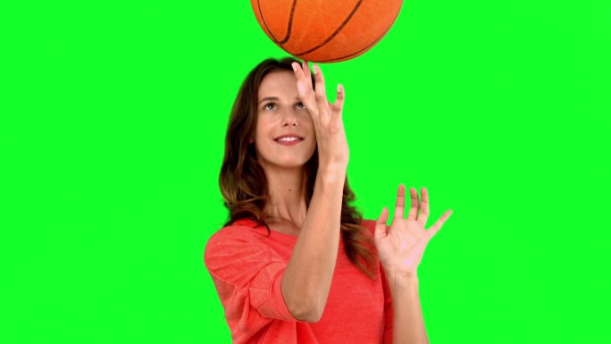 女人在绿色背景下打篮球特写