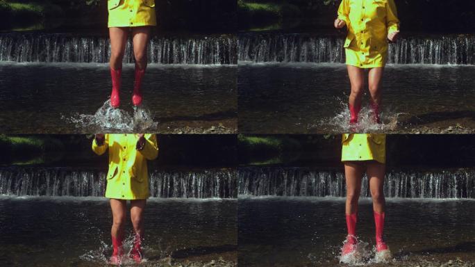 穿着粉红色橡胶靴子的女人在瀑布前溅水