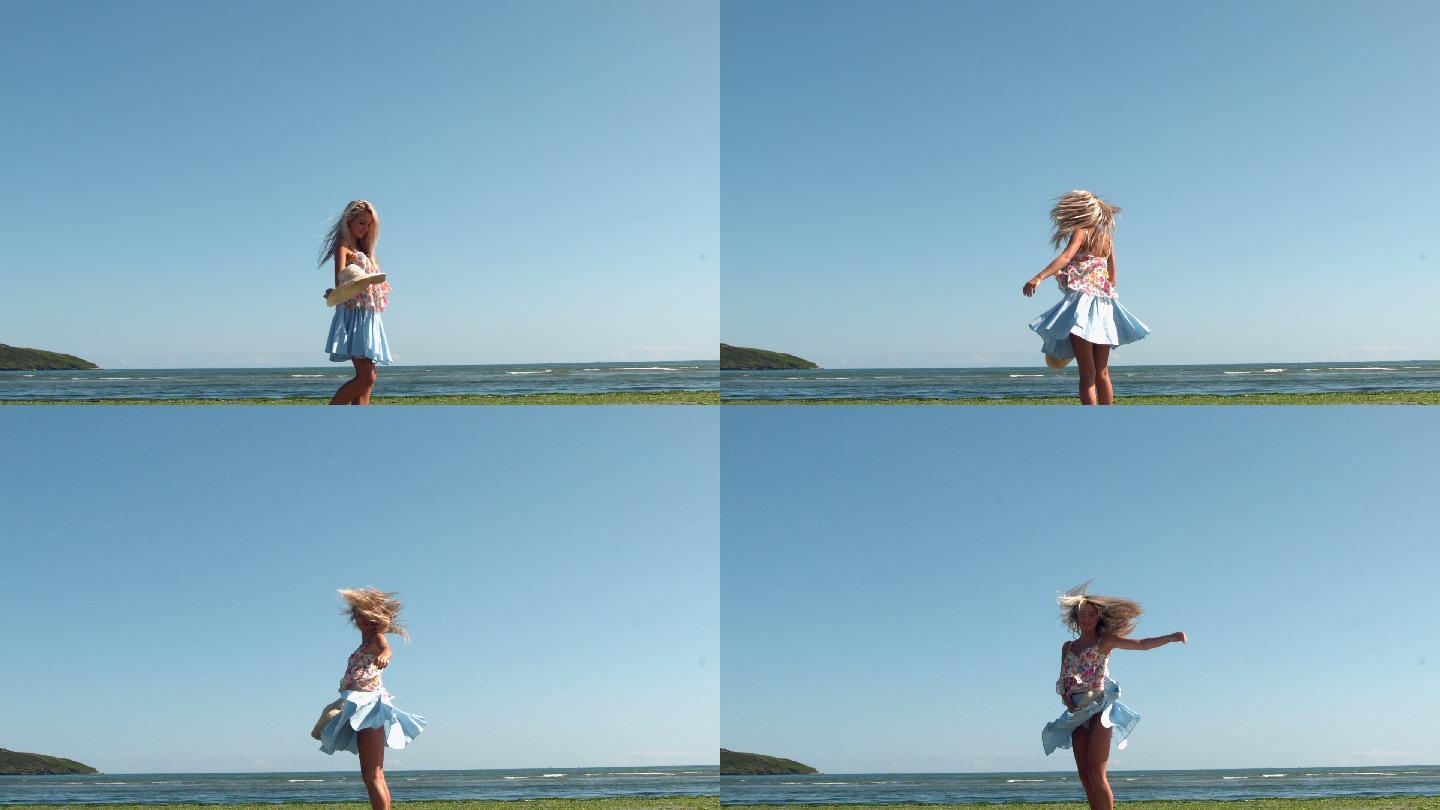 在慢镜头中，漂亮的金发女郎拿着草帽在海滩上旋转