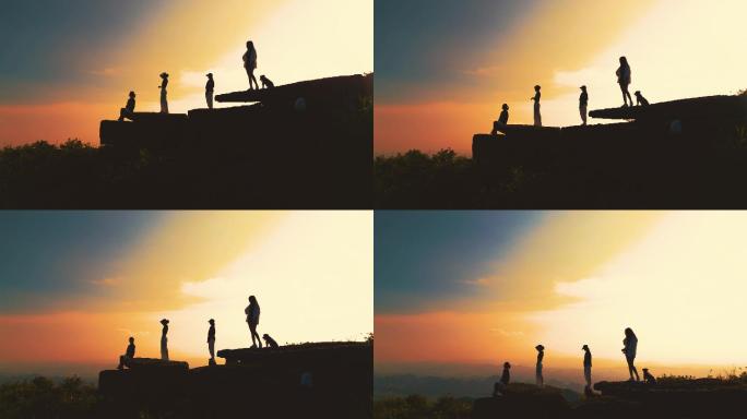 黄昏日落山顶上看风景的美少女黄昏人物剪影