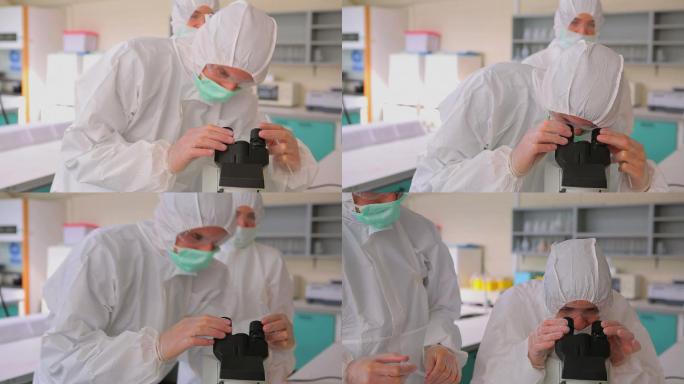 两个学生在用显微镜做研究