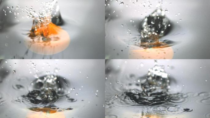 一个橙子落入水中特写
