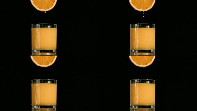 橙汁从橙子中滴落到杯子里特写