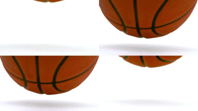 篮球在白色的背景下落在地板上