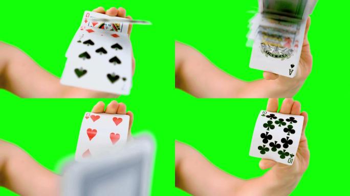 绿色屏幕上人的手推扑克牌特写