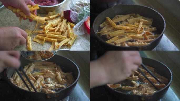 中国厨房里一位厨师在炸腐竹