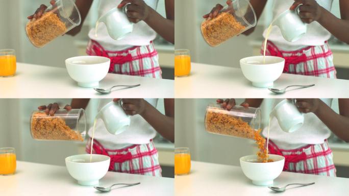 用慢镜头将牛奶和麦片倒进碗里的女人