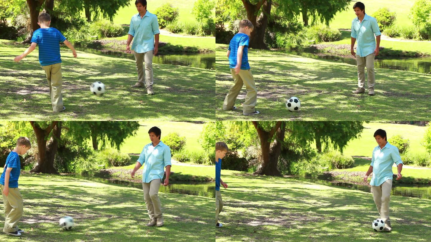 父亲和儿子在公园踢足球特写