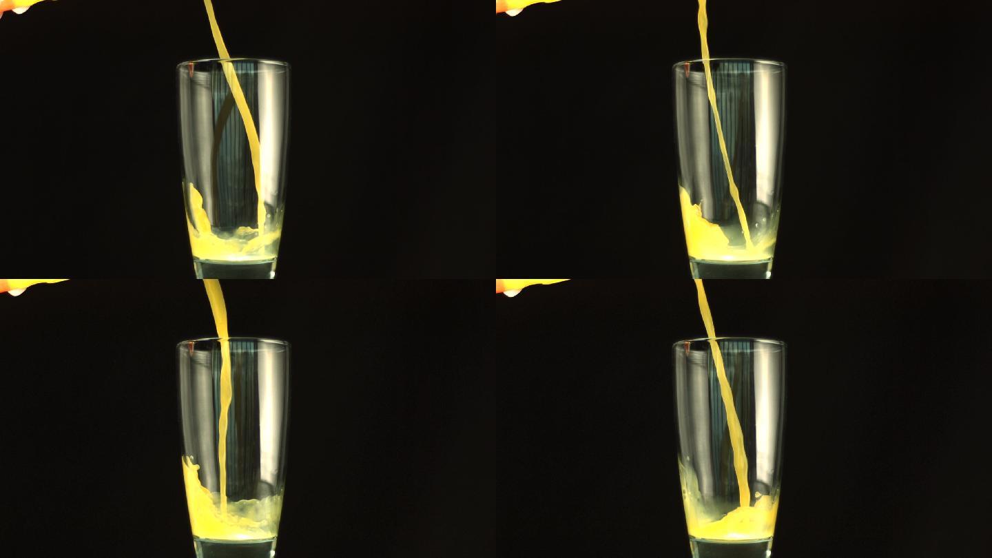 慢镜头里，橙汁倒在杯子里