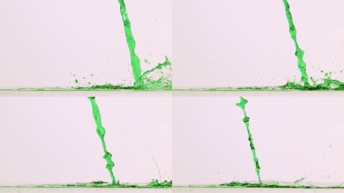 绿色液体以超慢的动作倒在白色背景的表面上