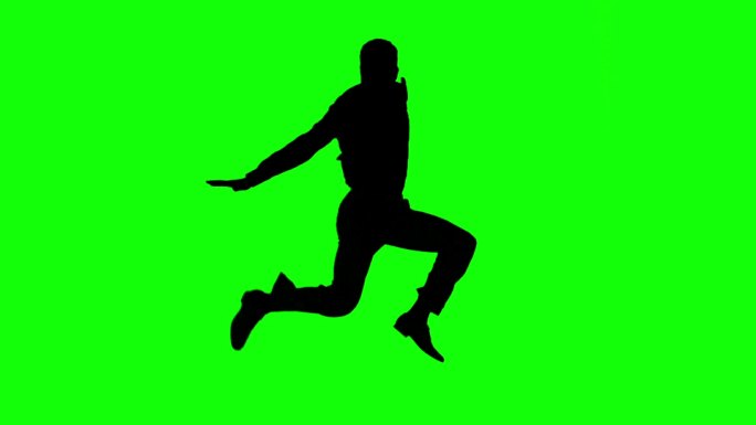 一个人在绿色屏幕上跳跃的剪影在慢镜头中