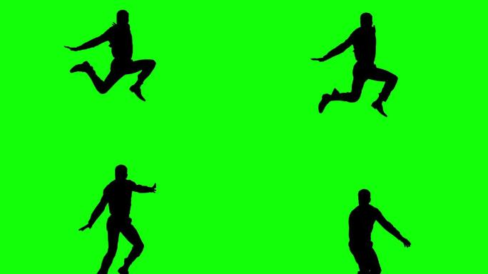 一个人在绿色屏幕上跳跃的剪影在慢镜头中