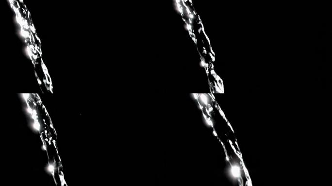 特写，细流的水在一个超级缓慢的运动流动在一个黑色的背景