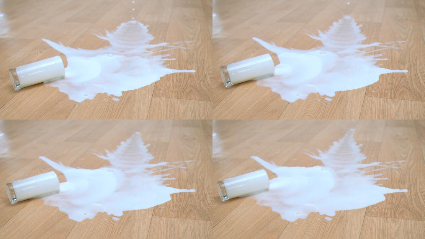 一杯牛奶摔到地板上特写