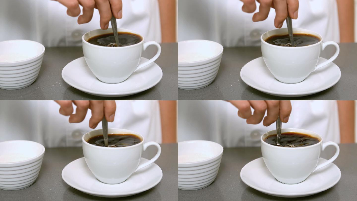 用手搅拌咖啡杯，以慢动作靠近