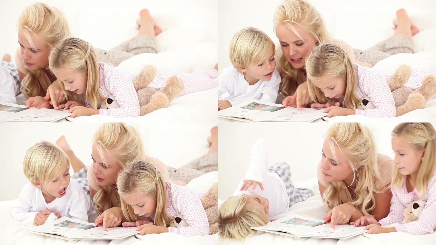 母亲在床上给她的孩子读书