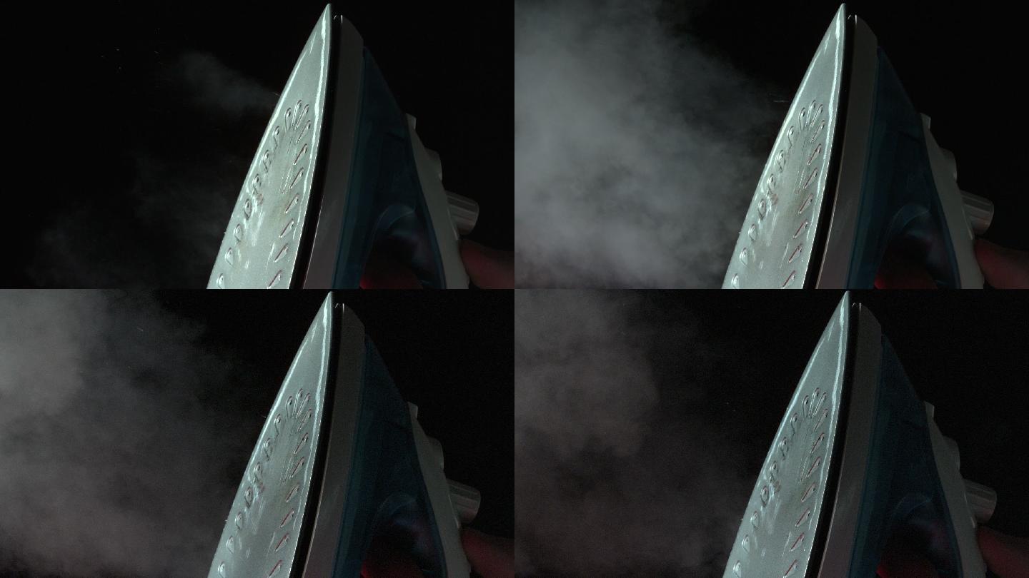 慢镜头中，铁在黑色背景上释放蒸汽