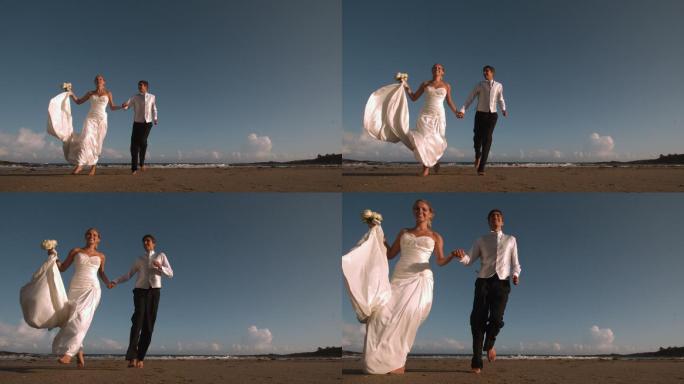 欢快的新婚夫妇在海滩上慢镜头奔跑