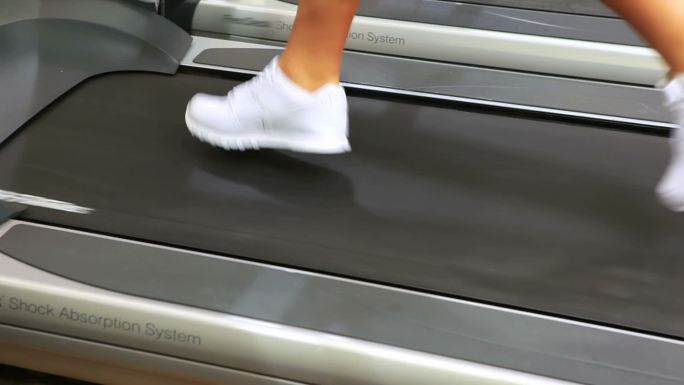 Feet running on treadmill in gym