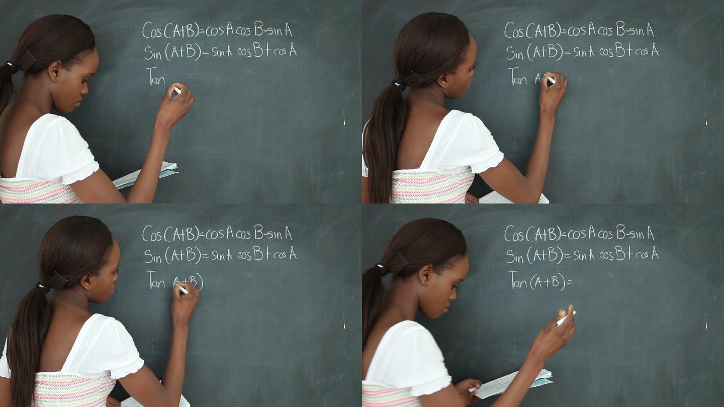 一个学生在教室的黑板上写数学题特写