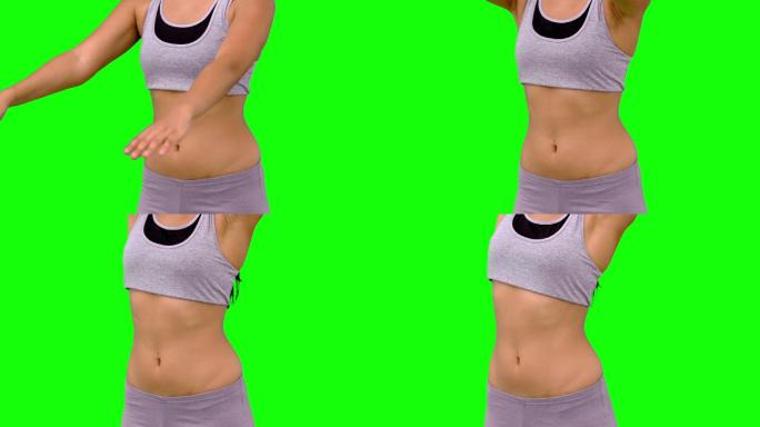 绿色屏幕下女人穿着运动服锻炼特写