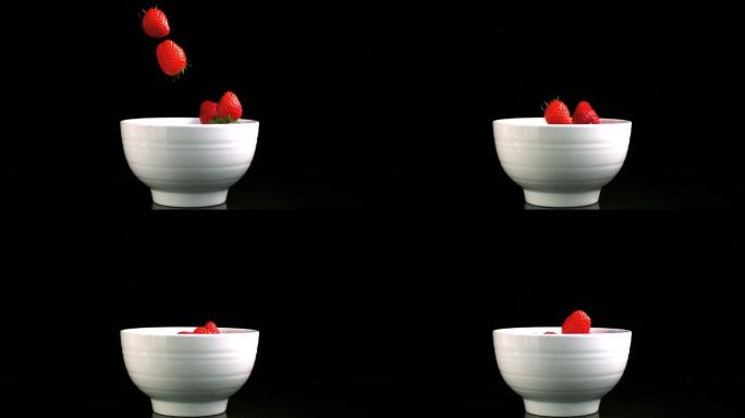 草莓落在一个白色的碗里特写