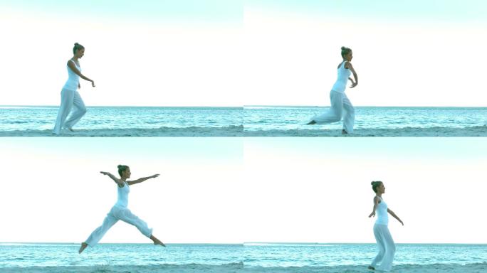 迷人的女人在海滩上慢动作跳舞