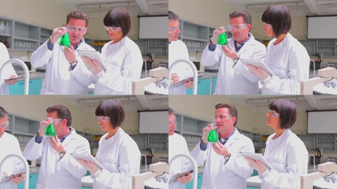 化学家们在实验室里观察烧杯里的液体特写