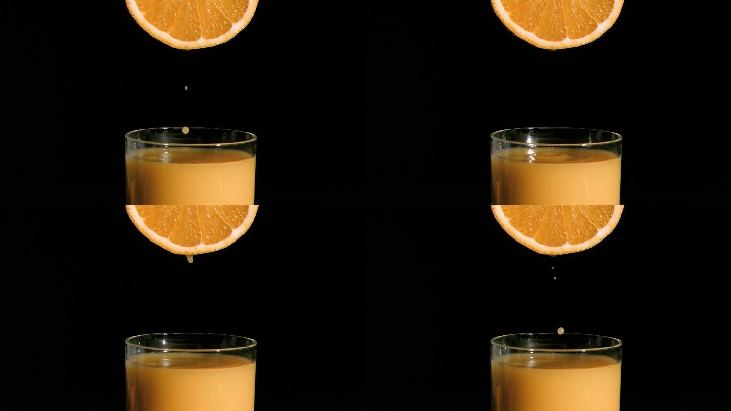 橙汁从橙子中流出落到玻璃杯中特写