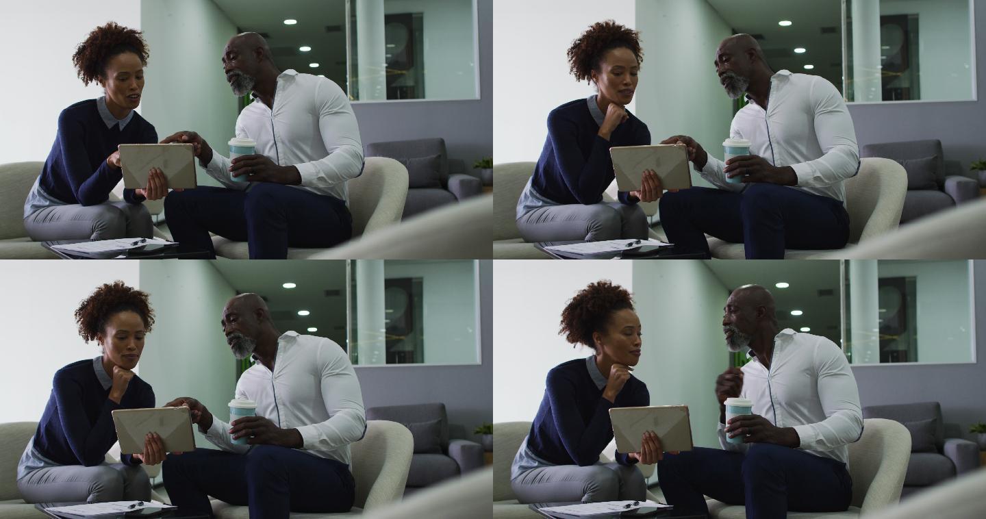 不同的男性和女性商务同事在交谈，女性在办公室里拿着数字平板电脑