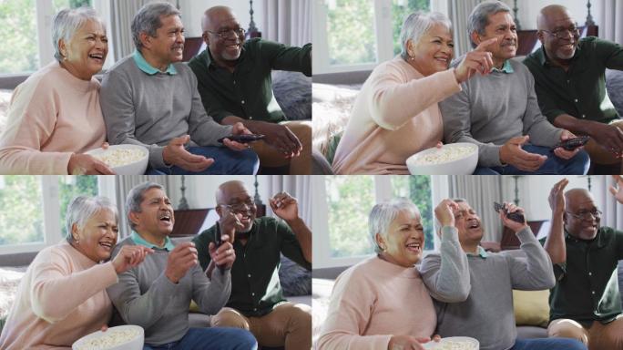 快乐的黑白混血老年夫妇和非洲裔美国朋友看电视爆米花