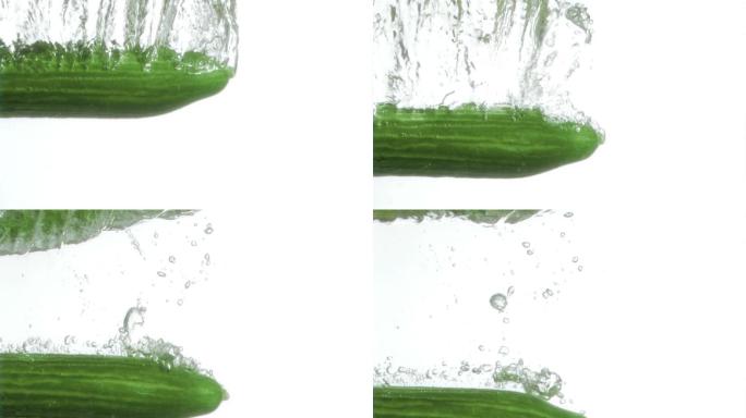 半根黄瓜在白色背景下以超慢的动作落进水里