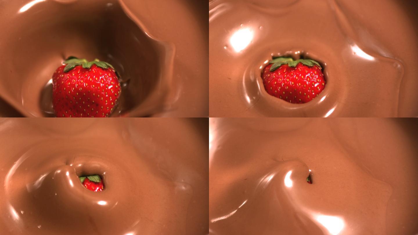 草莓落入融化的巧克力中的慢镜头