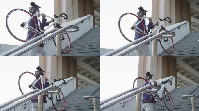 戴着口罩的亚洲男子拿着自行车在公司园区爬楼梯