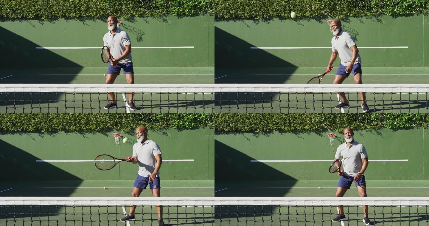 一个非洲裔美国老人在一个阳光明媚的日子在网球场上打网球