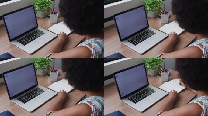 非裔美国商人在视频电话，记笔记，使用笔记本电脑与复制空间在屏幕上