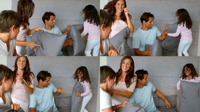 微笑的一家人在玩枕头大战，慢镜头250帧每秒