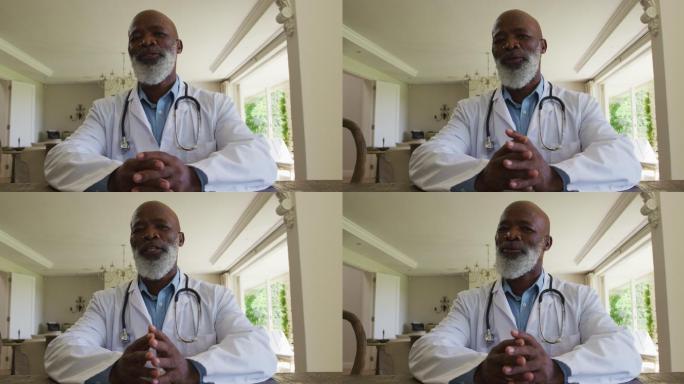 非裔美国资深男医生的肖像在家里看着相机说话