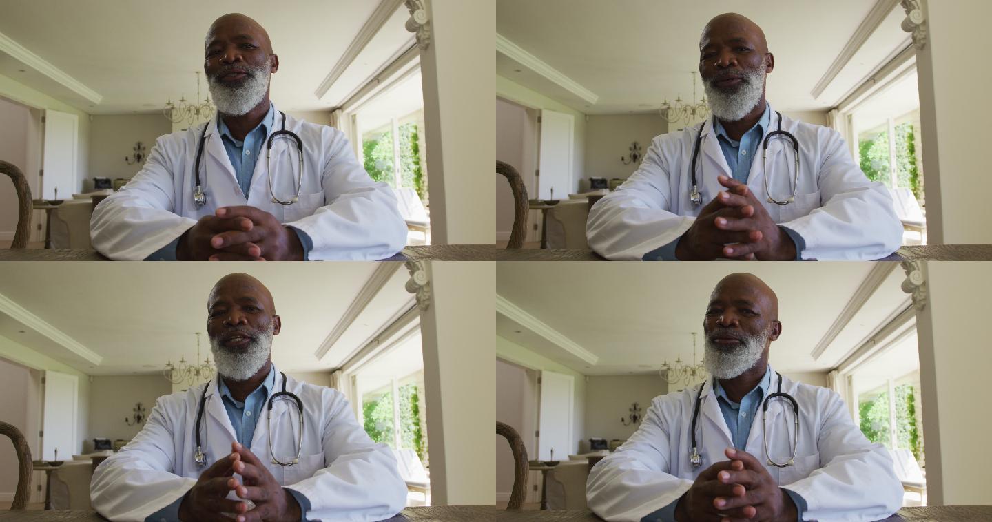 非裔美国资深男医生的肖像在家里看着相机说话