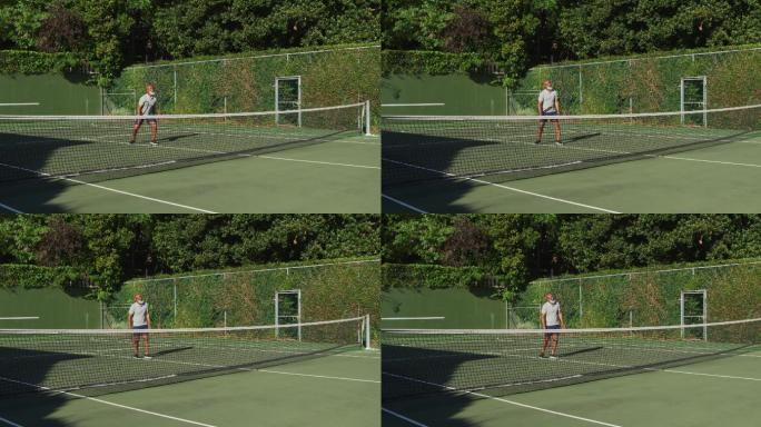一个非洲裔美国老人在一个阳光明媚的日子在网球场上打网球