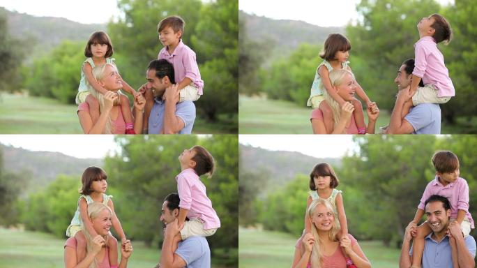 在公园里父母把孩子扛在肩上特写