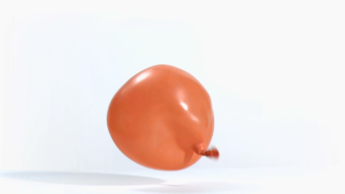 橙色气球在白色背景中落下特写