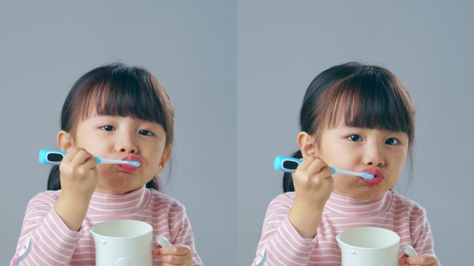 刷牙的小女孩杯子漱口小女孩