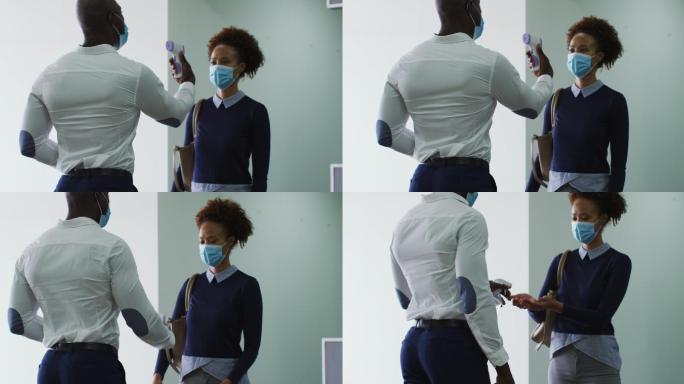 非裔美国商人戴着口罩给到达办公室的女同事消毒双手