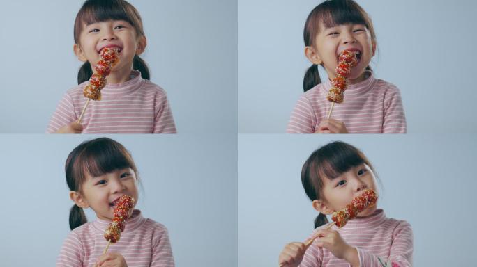 吃糖葫芦的小女孩零食笑容开心
