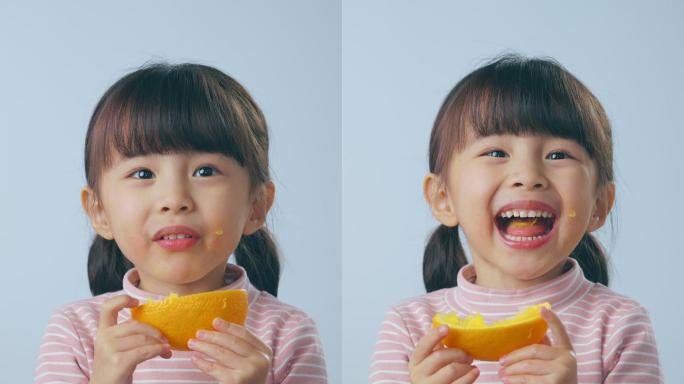 吃橙子的小女孩竖屏开心大笑可爱