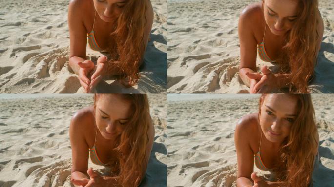 美丽的年轻白种女人在比基尼放松在沙滩上的阳光4k