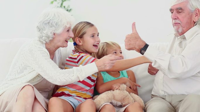 Children playing with grandparents on the couch